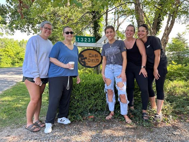 Friends of Mallorie Hook in Front of Casi Cielo Vacation Rental Sign