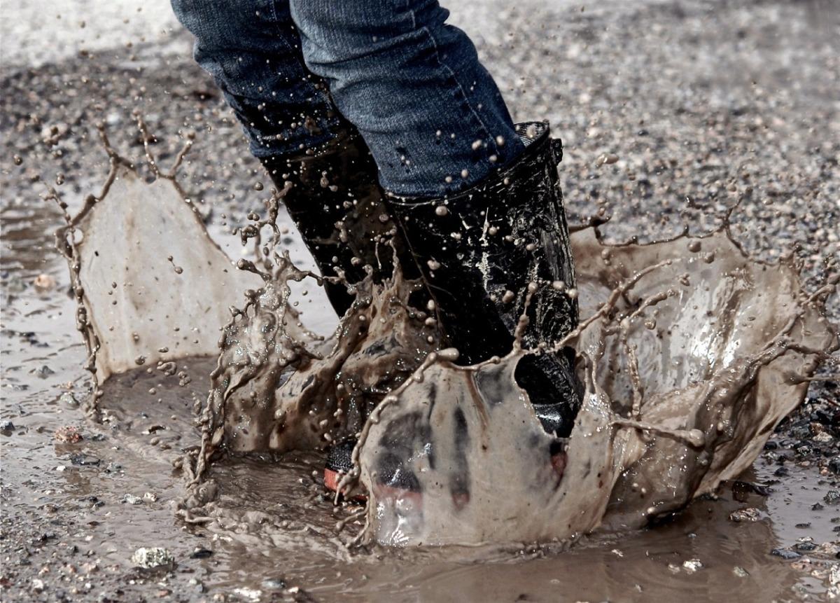 Person Jumping Into Mud Puddle